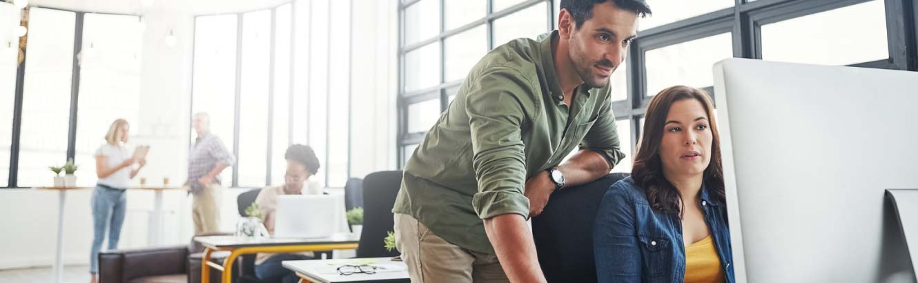 two people working at a computer 